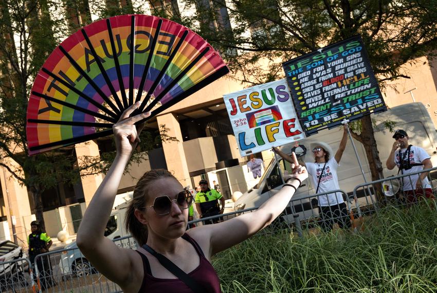 A demonstrator flips off counter protestors before a march against the overturning of Roe v. Wade, which virtually bans abortion in the state of Texas, on June 24, 2022.